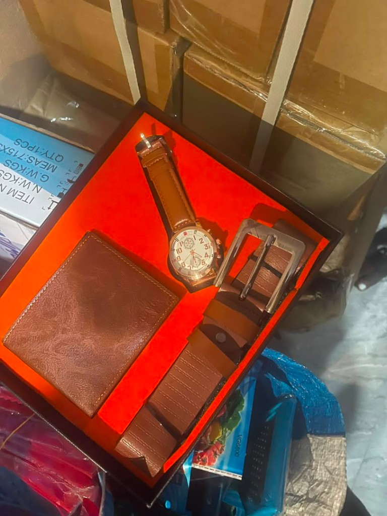 Brown leather wallet, gold watch, and belt gift set