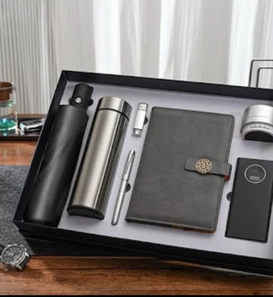 Black executive gift set with umbrella, thermos, pen, USB, notebook, speaker, and power bank