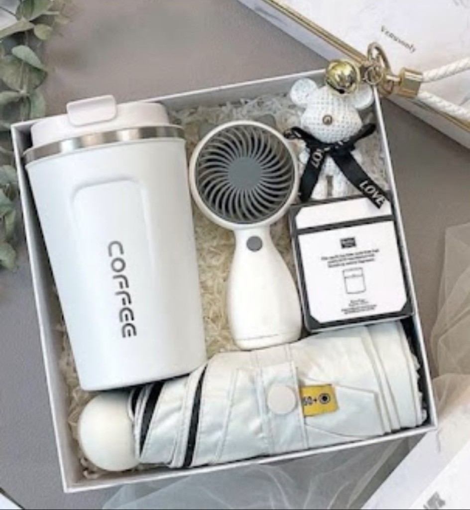 White gift set with coffee tumbler, fan, umbrella, and teddy bear charm